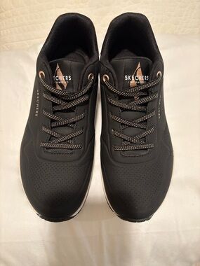 Skechers women’s Black Athletic Slip On Sneakers with Rose Gold Accents